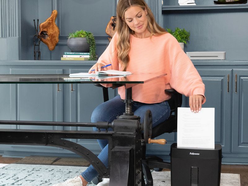 a woman using paper shredder