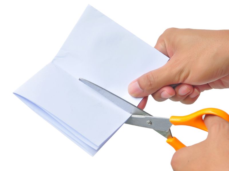 manually-cutting-papers-or-documents-with-scissor-image